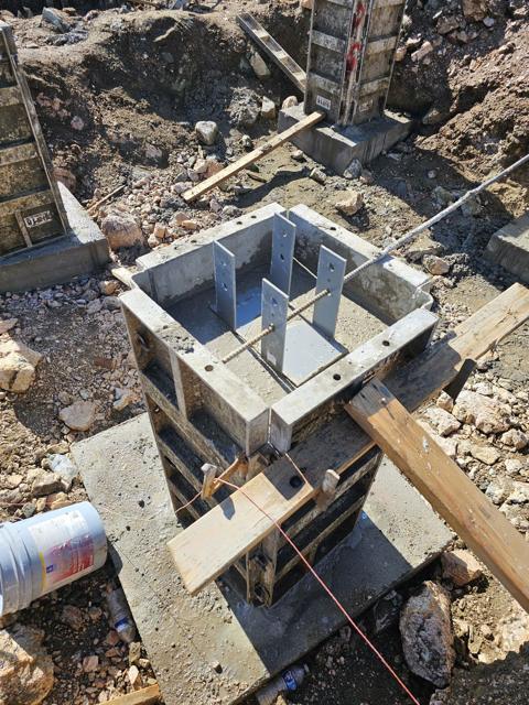 Post bases set in the pier tops