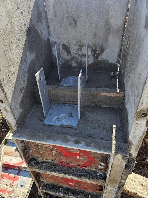 Steel post base in a finished pier